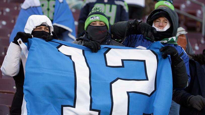 Seattle Seahawks fans hold a sign before an NFL wild-card football game against the Minnesota Vikings, Sunday, Jan. 10, 2016, in Minneapolis. (AP Photo/Nam Y. Huh)