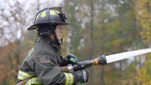Grace Robertson, a Cherokee County firefighter, releases water from a 1 3/4-inch hand line. CONTRIBUTED BY ANNA MACKENZIE