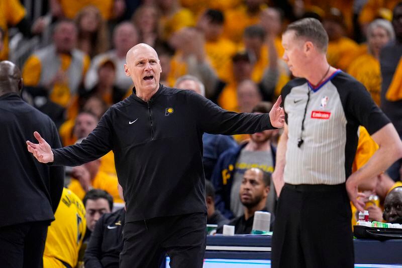 Indiana Pacers head coach Rick Carlisle questions referee Ed Malloy (14) during the second half against the Milwaukee Bucks in Game 2 in an NBA basketball first-round playoff series, Friday, April 26, 2024, in Indianapolis. (AP Photo/Michael Conroy)