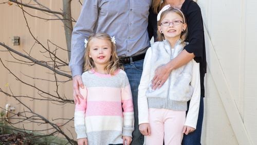 Patrick and Madelyn Gahan of west Cobb, with their daughters, Mya and Anya. Mya (the smaller girl) had a heart transplant at the age of 3. She is now 7 and doing well. (Lindsay Larson / Special)
