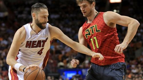 Josh McRoberts (4) of the Heat drives on Tiago Splitter (11)of the Hawks during a game last season. (Photo by Mike Ehrmann/Getty Images)