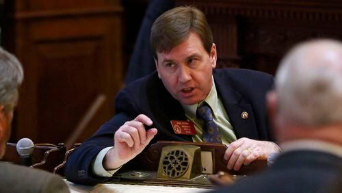 State Rep. Jesse Petrea, R-Savannah, confers with others on the floor of the Georgia House. He’s the author of House Bill 657, which would make it illegal for a person to “knowingly and intentionally” provide a firearm to someone convicted of a felony. BOB ANDRES / BANDRES@AJC.COM