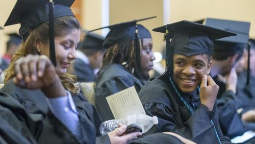 Matthew McKenzie, 14, (right) jokes with Whitney Durrance (left) before the 2018 Chattahoochee Technical College commencement ceremony in Cartersville, Thursday, May 10, 2018. This year, Matthew, a Cobb County resident, is the youngest graduate from Chattahoochee Technical College. His mother, Monique McCord, home-schooled him since second grade and used a waiver from the college to dual-enroll Matthew. ALYSSA POINTER/ALYSSA.POINTER@AJC.COM