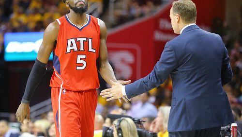 The Hawks' DeMarre Carroll gets a handshake from head coach Mike Budenholzer who begins to pull his starters in the final period of a 118-88 loss to Cleveland, which completed a sweep in the Eastern Conference Finals on Tuesday. (Curtis Compton/ccompton@ajc.com)