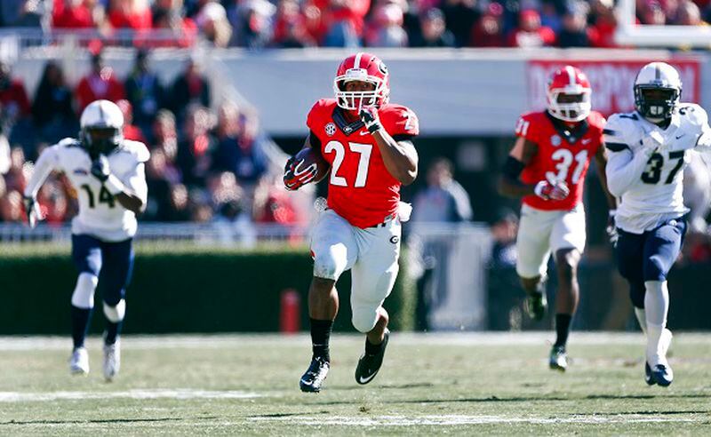 Georgia running back Nick Chubb (27) breaks free for a touchdown as Charleston Southern defensive backs Malcolm Jackson (14) and Davion Anderson (37) give chase during the first half of an NCAA college football game, Saturday, Nov. 22, 2014, in Athens, Ga. (AP Photo/John Bazemore) There he goes again. (John Bazemore/AP photo)
