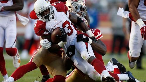 Arizona Cardinals' Adrian Peterson (23) is tackled by San Francisco 49ers' Eric Reid (35) and San Francisco 49ers' Leger Douzable (92) in the third quarter on Sunday, Nov. 5, 2017 at Levi&apos;s Stadium in Santa Clara, Calif. (Nhat V. Meyer/Bay Area News Group/TNS)