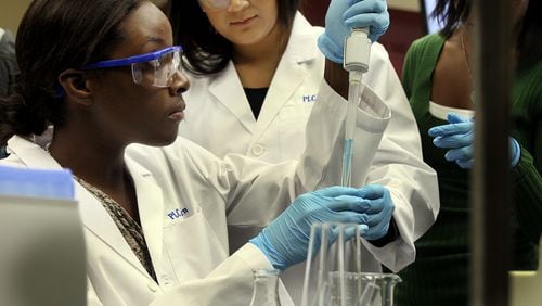 File photo: Cobb’s Performance Learning Center students Tiara Hamilton (left) & Valeria Puerta perform lab experiments using a Spectrophotometer at Kennesaw State University. Phil Skinner pskinner@ajc.com