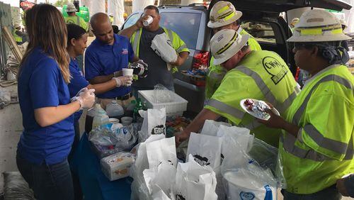 Tower employees serve construction workers lunch to thank them for rebuilding a collapsed portion of I-85.