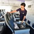 Danette Coombs, flight attendant, shows Delta's Airbus A350 Premium Select seat. (Hyosub Shin/Atlanta Journal-Constitution/TNS)