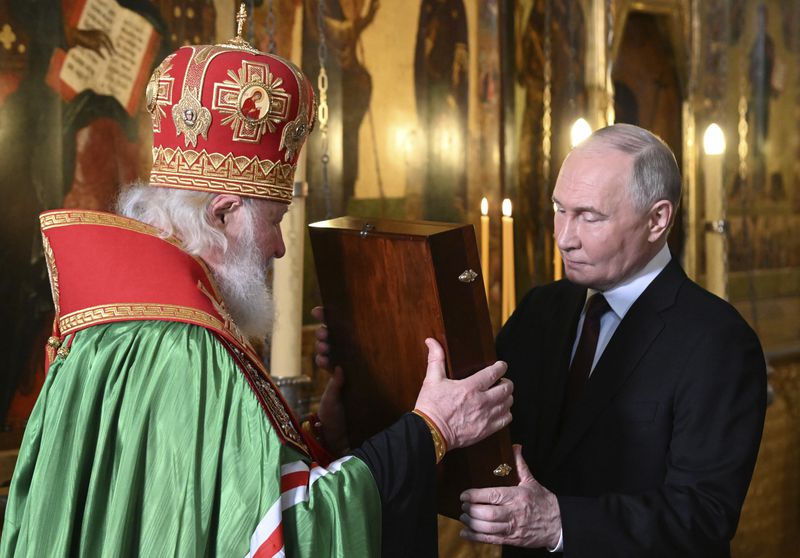 Russian President Vladimir Putin, right, and Patriarch Kirill of Moscow and all Russia attend a prayer service following an inauguration ceremony at the Kremlin's Annunciation Cathedral in Moscow, Russia, Tuesday, May 7, 2024. (Alexey Maishev, Sputnik, Kremlin Pool Photo via AP)