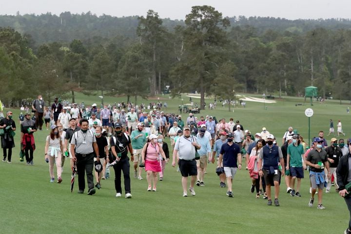 April 10, 2021, Augusta: Patrons leave the course as play is suspended because of a weather warning during the third round of the Masters at Augusta National Golf Club on Saturday, April 10, 2021, in Augusta. Curtis Compton/ccompton@ajc.com