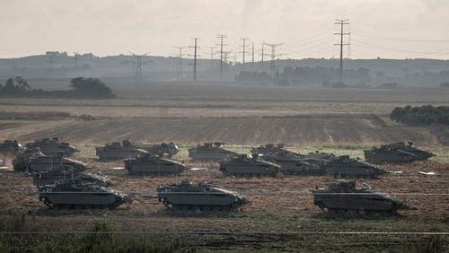  Israeli tanks on a field as they prepare to move towards the Gaza Strip, outside Erez, Israel, on Sunday, Oct. 15, 2023. (Sergey Ponomarev/The New York Times) 