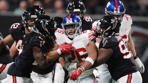 The Falcons D, here making life uncomfortable for New York Giants running back Saquon Barkley, will get no reinforcement through the trade market. (Curtis Compton/ccompton@ajc.com)