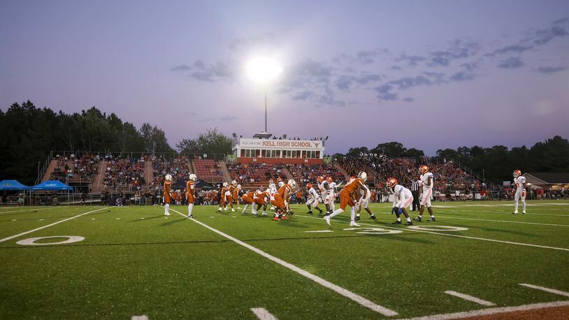 The sun sets as the Kell offense prepares for a play against the Parkview defense during the first half in the 2023 Corky Kell + Dave Hunter Classic at Kell High School, Wednesday, August 16, 2023, in Marietta, Ga. (Jason Getz / Jason.Getz@ajc.com)