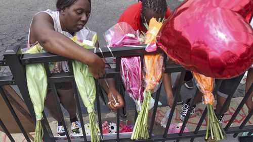People began showing up at Wendy's on University Avenue Sunday morning, June 14, 2020. Some helped with cleanup, some came to look, and some began placing flowers and created a memorial. (Photo: Steve Schaefer for The Atlanta Journal-Constitution)