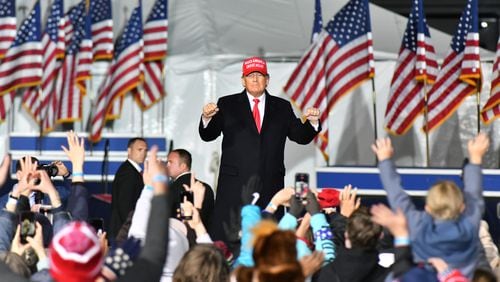 Former President Donald Trump dances as he leaves the stage during a rally for Georgia GOP candidates at Banks County Dragway in Commerce on Saturday, March 26, 2022. (Hyosub Shin / Hyosub.Shin@ajc.com)
