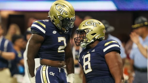 Georgia Tech linebacker Ayinde Eley (2) and defensive lineman Makius Scott (8) celebrate during the first half of the Chick-fil-A Kickoff game against Clemson at Mercedes-Benz  stadium on Monday, September 5, 2022. (Arvin Temkar / arvin.temkar@ajc.com)