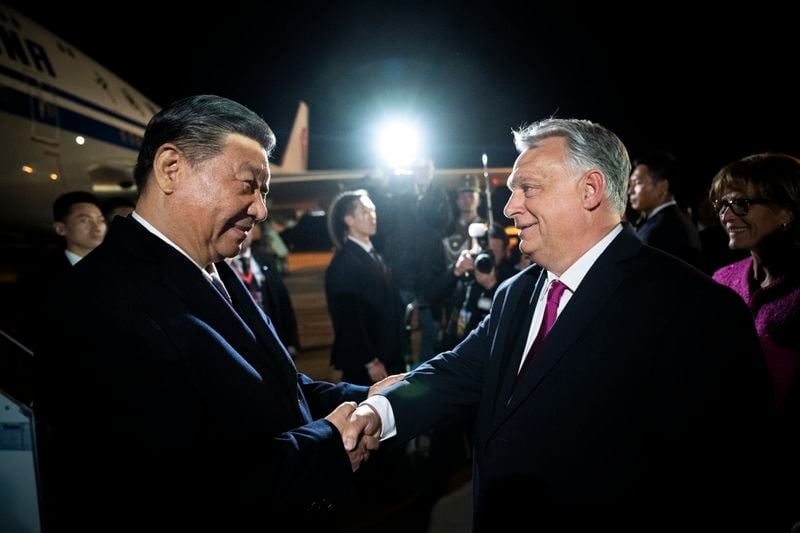 In this image provided by the Hungarian Prime Minister's Office, Chinese President Xi Jinping, left, shakes hands with Hungarian Prime Minister Viktor Orban as he arrives for a state visit at the Liszt Ferenc International Airport in Budapest, Hungary, Wednesday, May 8, 2024. (Vivien Cher Benko/Hungarian Prime Minister's Office/MTI via AP)