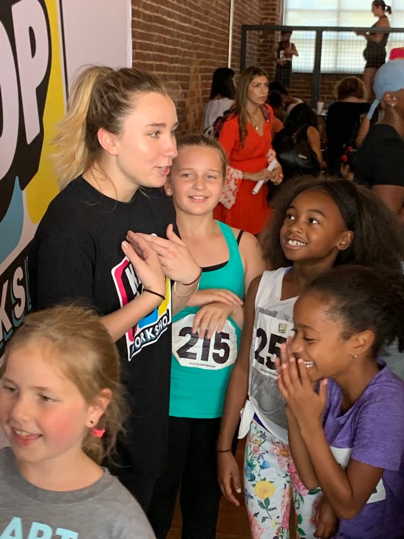 Former Kidz Bop kid Ashlynn, 18, (far left)  shares a laugh with kids at the Kidz Bop workshop in Atlanta. The workshop gives kids the opportunity to work with Kidz Bop trainers on dancing, singing and camera presence.