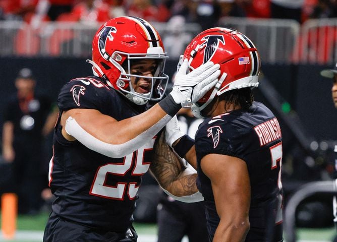 Atlanta Falcons running back Bijan Robinson (7) is congratulated by Tyler Allgeier (25) after he ran for a touchdown during the second quarter of a NFL football game against the New Orleans Saints in Atlanta on Sunday, Nov. 26, 2023.   (Bob Andres for the Atlanta Journal Constitution)