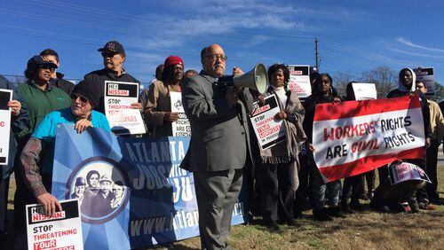 Protesters say Nissa has suppressed worker rights in Mississippi. Here, state Sen. Vincent Fort speaks to protesters.