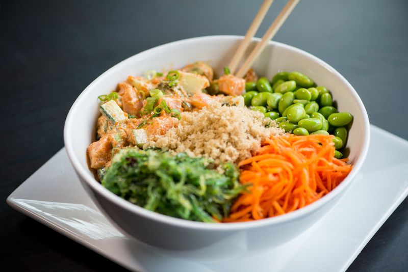  CO Spicy Salmon Crunch Bowl with avocado, cucumber, masago, tempura flakes, edamame, pickled carrots, seaweed salad, served over maze gohan rice. Photo credit- Mia Yakel.
