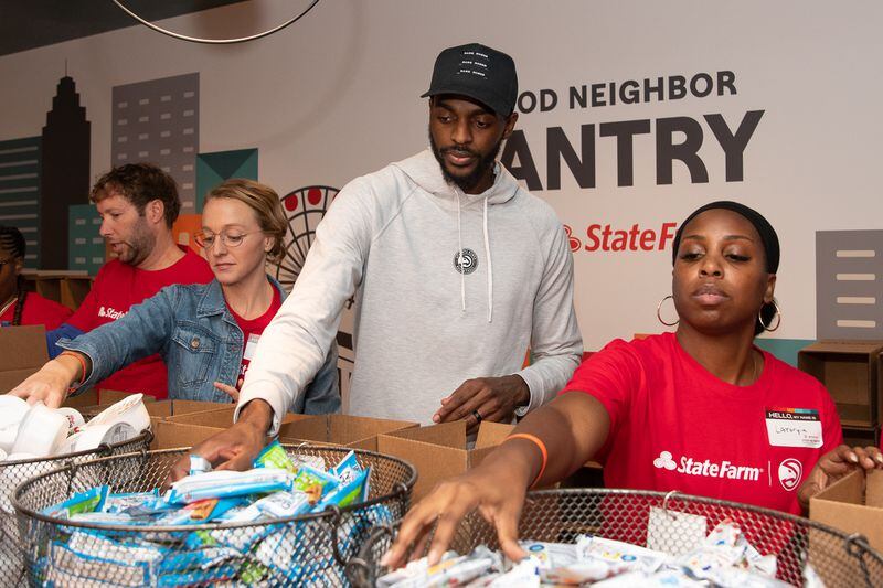 Justin Holiday, a forward with the Hawks, also showed support by helping stock the pantry and packing a few boxes. Holiday said he likes to give back because he remembers what the holidays were like for him when he was growing up.