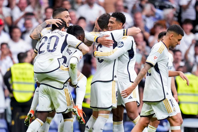 Real Madrid's Jude Bellingham, center right, celebrates after scoring his side's second goal during the the Spanish La Liga soccer match between Real Madrid and Cadiz at the Santiago Bernabeu stadium in Madrid, Spain, Saturday, May 4, 2024. (AP Photo/Manu Fernandez)