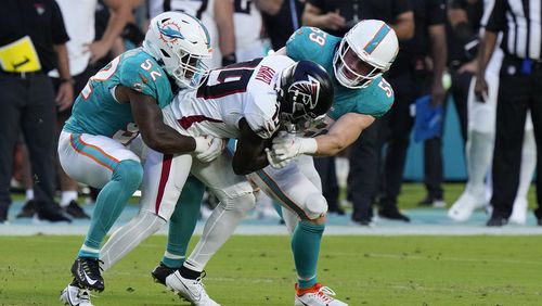 Miami Dolphins linebackers Aubrey Miller II (52) and Mike Rose take down Atlanta Falcons wide receiver Penny Hart (19) during the first half of a preseason NFL football game, Friday, Aug. 11, 2023, in Miami Gardens, Fla. (AP Photo/Wilfredo Lee)