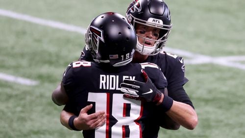 Falcons quarterback Matt Ryan greets wide receiver Calvin Ridley (18) on the field before their game against the Carolina Panthers Sunday, Oct. 11, 2020, at Mercedes-Benz Stadium in Atlanta. (Jason Getz/For the AJC)