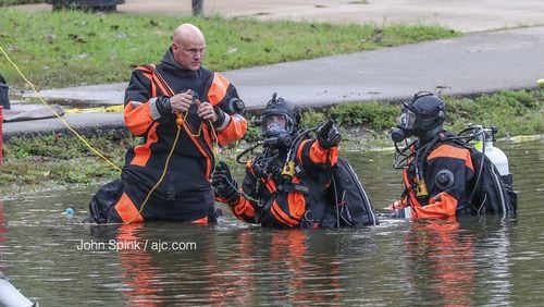 Dive crews investigate the car that had become submerged in Buena Vista Lake on Wednesday night.