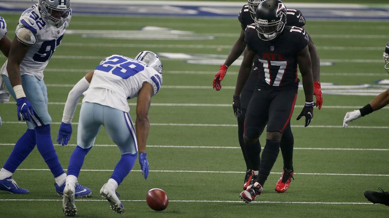 Falcons wide receiver Olamide Zaccheaus (17)  watches the onside kick roll before Dallas cornerback C.J. Goodwin (29) dives on the ball to recover the ball for the Cowboys in the closing minutes Sunday, Sept. 20, 2020, in Arlington, Texas. The recovery led the Dallas' 40-39 victory over Atlanta. (Ron Jenkins/AP)