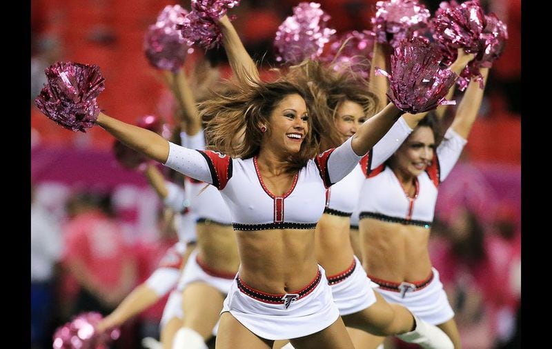 The Falcons cheerleaders sport pink pom poms for breast cancer awareness as they preform during the game against the Texans on Sunday, Oct. 4, 2015, in Atlanta. Curtis Compton