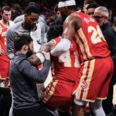 Atlanta Hawks forward Saddiq Bey (41) is getting help from doctors and teammates after injuring his leg during the second half of the game against the New Orleans Pelicans at State Farm Arena on Sunday, March 10, 2024, in Atlanta.

 Miguel Martinez / miguel.martinezjimenez@ajc.com