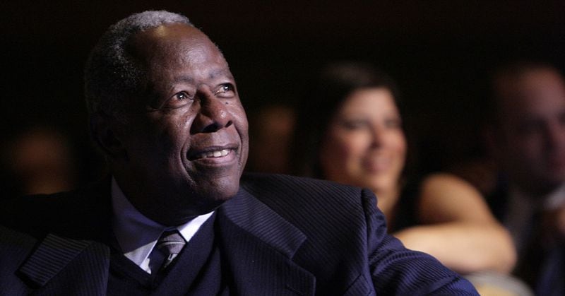 ORIGINAL CAPTION. Hank Aaron, who hit 755 career home runs in the baseball’s majors, listens to tributes to him on the stage during a celebration of his 75th birthday, Feb. 5, 2009, in Atlanta. (John Amis/Associated Press)