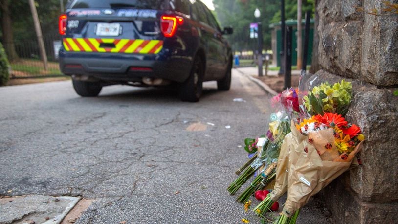 Flowers and dog treats are left near the location where stabbing victim Katherine Janness' body was found in Piedmont Park.