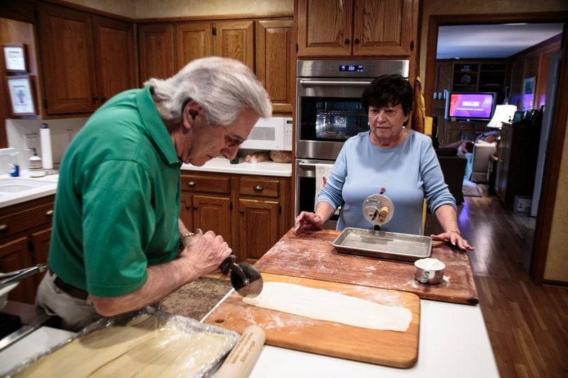 Charlie Augello divides the dough for the fresh Cavatelli noodles as his wife Anita Augello waits to roll them out before a big family dinner Sunday in their Sandy Springs home June 4, 2017. STEVE SCHAEFER / SPECIAL TO THE AJC