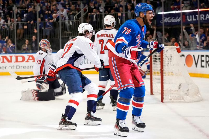 New York Rangers' K'Andre Miller (79) celebrates after shooting the puck past Washington Capitals goaltender Charlie Lindgren (79) for a goal during the second period in Game 2 of an NHL hockey Stanley Cup first-round playoff series, Tuesday, April 23, 2024, in New York. (AP Photo/Frank Franklin II)