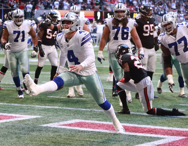 Dallas Cowboys quarterback Dak Prescott reacts to scoring a touchdown on a quarterback keeper past Falcons safety Damontae Kazee for a 12-9 lead during the fourth quarter Sunday, Nov. 18, 2018, in Atlanta. Dallas beat the Falcons 22-19.  (Curtis Compton/ccompton@ajc.com)