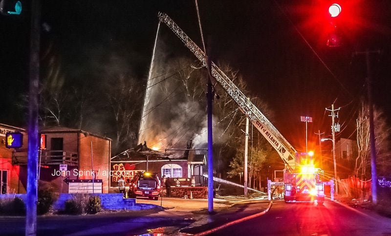 At one point, crews had to back off firefighting efforts because the restaurant's roof started to collapse, according to Atlanta fire officials.  JOHN SPINK / JSPINK@AJC.COM