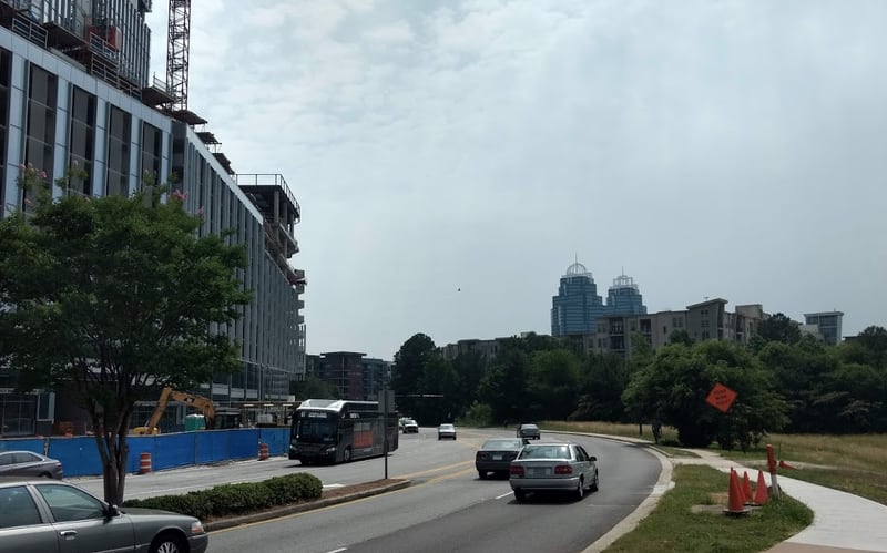 Smoke from distant wildfires may be mixing with clouds over Atlanta, although it's too high up to make the air unsafe. The King and Queen buildings rise above Hammond Drive . To the left is a State Farm building under construction. (Brian O'Shea, bposhea@ajc.com)