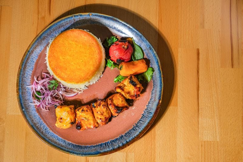 Koobideh and kabob entrees come with a choice of polo rice at Chelo. Pictured is the chicken koobideh with sabzi polo. Courtesy of Chelo