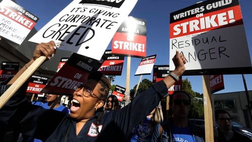 Actor and writer Daheli Hall, left, joins WGA members as they cheer on the first day of their strike in front of Paramount Studios on May 2, 2023, in Hollywood. (Genaro Molina/Los Angeles Times/TNS)