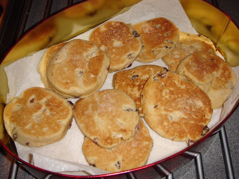 Welsh cakes, a popular teatime treat, are sweet griddle cakes studded with raisins and dusted with sugar. (WIKIMEDIA COMMONS)