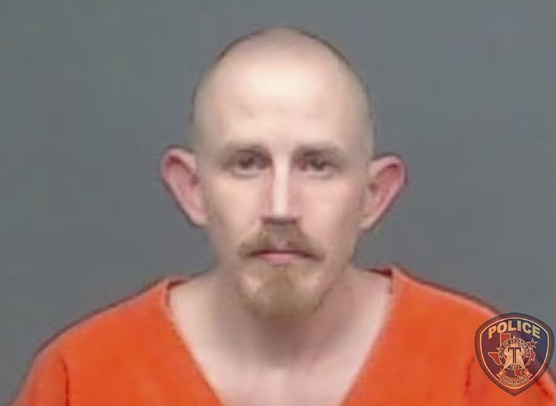 In this file image provided by the Texarkana, Texas, Police Department, Aaron Swenson is seen in his police booking photo. The Arkansas man, whose Facebook page included "boogaloo" references, was arrested on April 11 by police in Texarkana, Texas, on a charge he threatened to ambush and kill a police officer on a Facebook Live video. He was indicted June 11 on charges including attempt to commit capital murder of a peace officer.