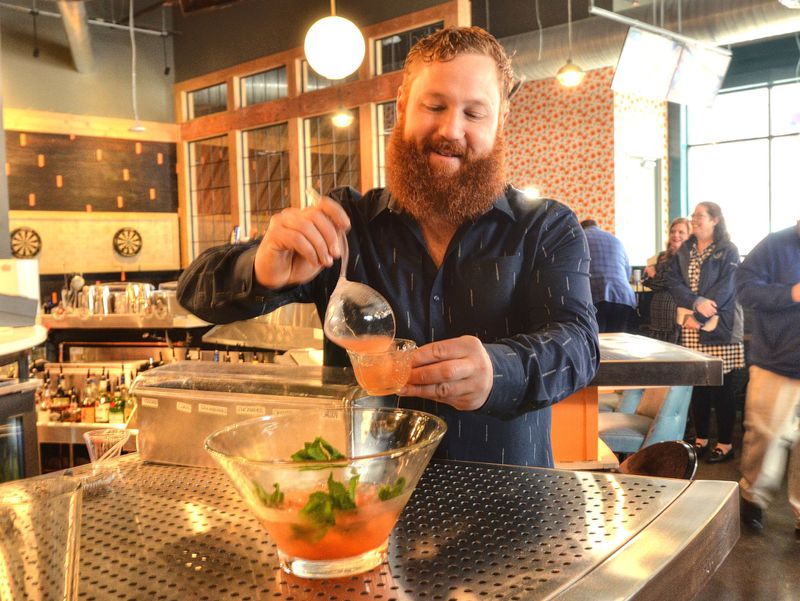 Punch Bowl Social’s resident mixologist and beverage director Patrick Williams pours one of his tequila concoctions called a Watermelon Polo Bowl during a media tour. Punch Bowl Social will open Saturday in The Battery Atlanta adjacent to SunTrust Park. CONTRIBUTED BY CHRIS HUNT
