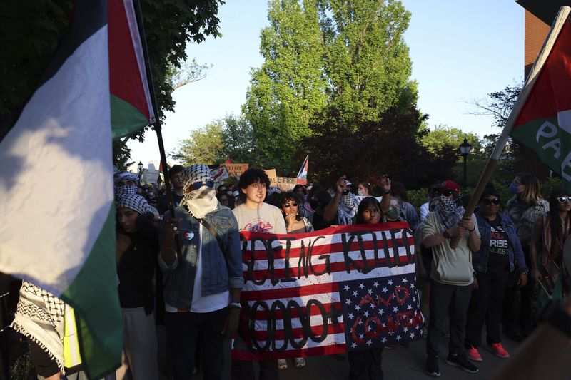 Pro-Palestinian protesters, including ones holding a sign tying Boeing and the United States to thousands of deaths in Gaza, march on the campus of St. Louis University, Wednesday night, May 1, 2024, in St. Louis. (David Carson/St. Louis Post-Dispatch via AP)