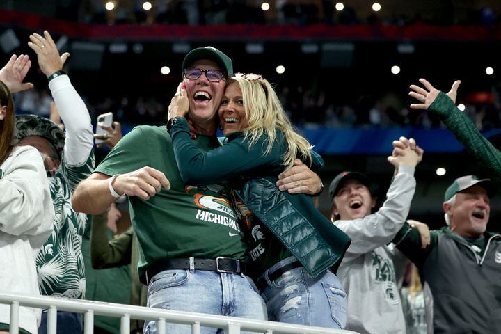 Michigan State Spartans fans celebrate a late interception to seal the Spartans' 31-21 win against the Pittsburgh Panthers during the Chick-fil-A Peach Bowl at Mercedes-Benz Stadium in Atlanta, Thursday, December 30, 2021. JASON GETZ FOR THE ATLANTA JOURNAL-CONSTITUTION
