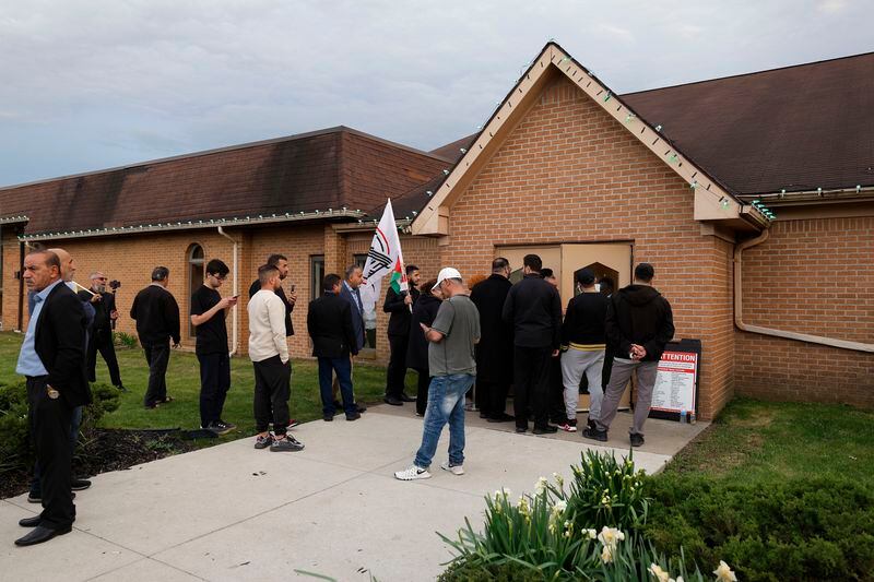 People gather outside the Islamic Institute of America in Dearborn Heights, Mich., hoping to see Iraq's Prime Minister Mohammed Shia al-Sudani, Thursday, April 18, 2024. (AP Photo/Al Goldis)