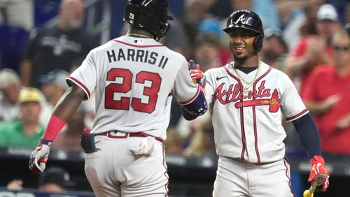 Atlanta Braves' Michael Harris II (23) is met by Ozzie Albies after hitting a solo home run during the fifth inning of a baseball game against the Miami Marlins, Saturday, Sept. 16, 2023, in Miami. (AP Photo/Lynne Sladky)